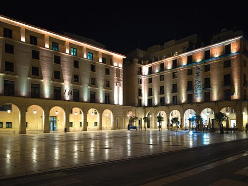 Free Elegant night view of Plaza de la Santísima Faz in Alicante, featuring illuminated historic buildings. Stock Photo