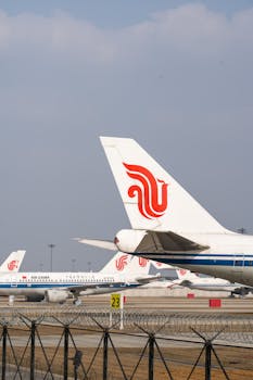 Air China planes parked at an airport tarmac under a clear sky, ready for departure.