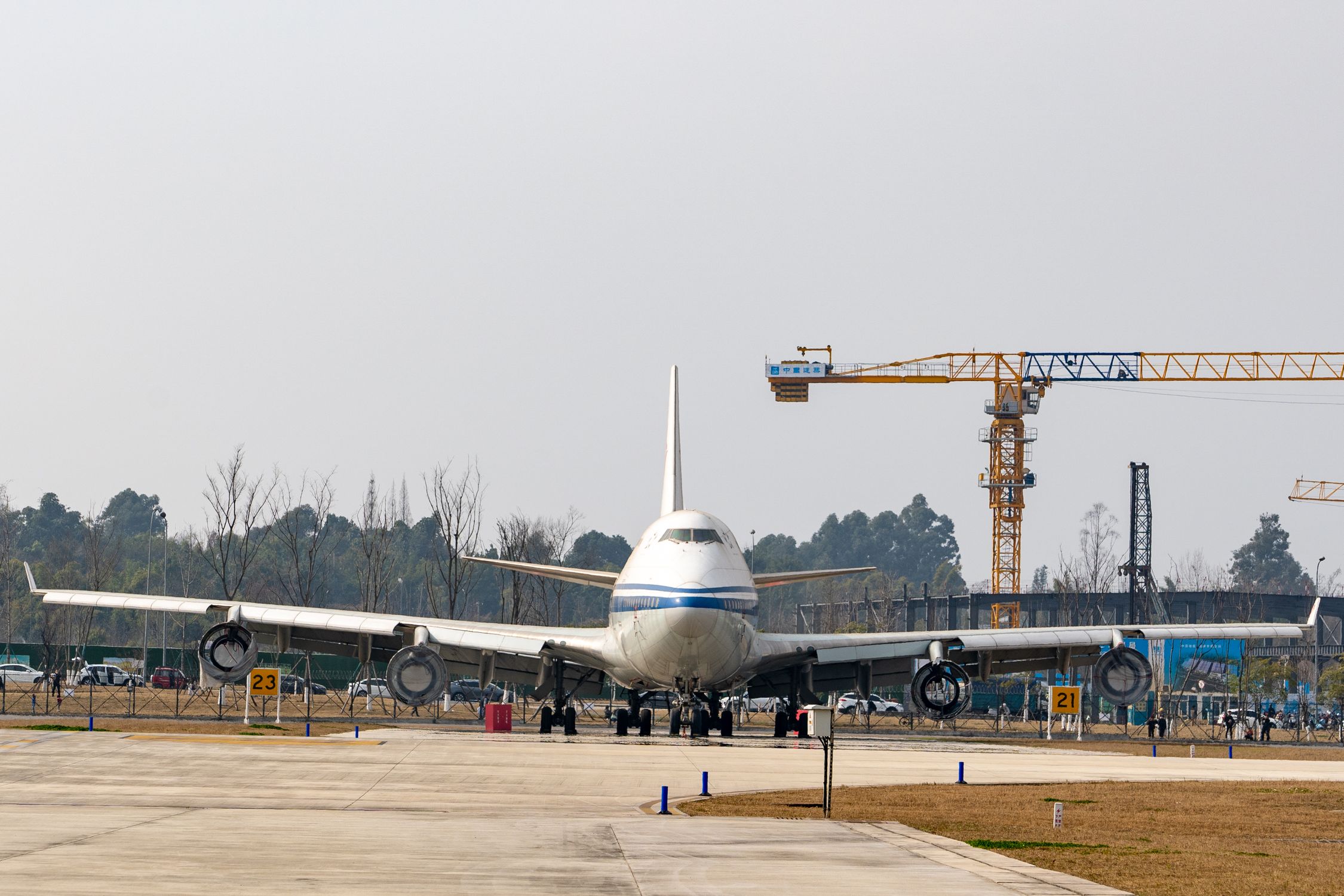 Plane In Construction Large Airplane Parked at Construction Site · Free Stock Photo