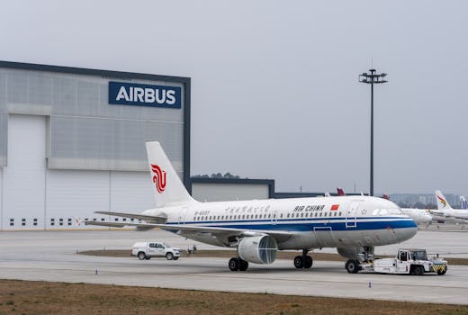 Air China Airbus A320 parked at Airbus hangar, showcasing aviation industry infrastructure.