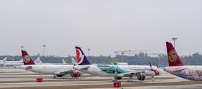 Airplanes Parked at a Busy Airport
