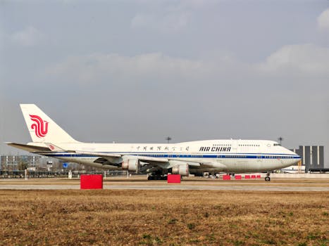 Air China Boeing 747 aircraft preparing for takeoff on a sunny day at an airport.