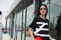 Stylish Woman in Sunglasses by Modern Building