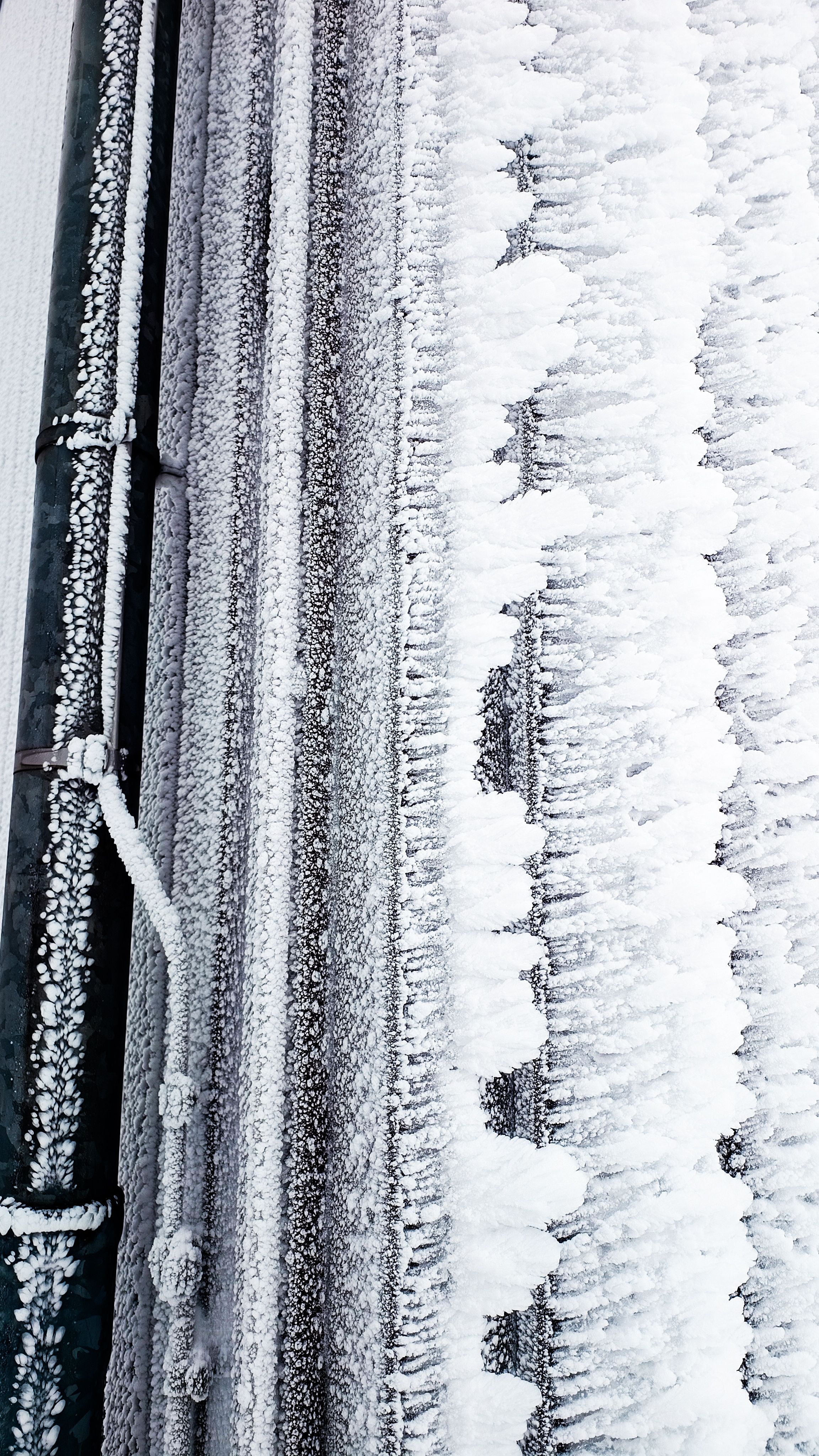 Close-up of frost-covered industrial pipes in Wernigerode, Germany during winter.