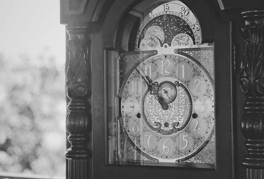 Detailed black and white image of a vintage grandfather clock face, captured in Bến Tre, Vietnam.