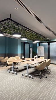 Contemporary conference room with beige chairs and plant decor. Perfect space for meetings.