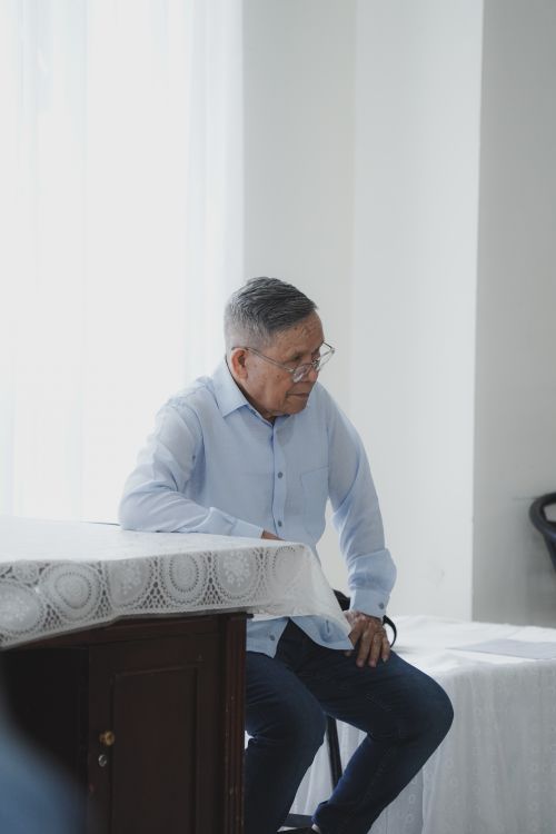 Free A senior man sitting in a bright room, pondering quietly in Jakarta, Indonesia. Stock Photo