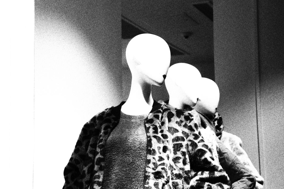 Vintage mannequins styled in classic mid-century coats and hats