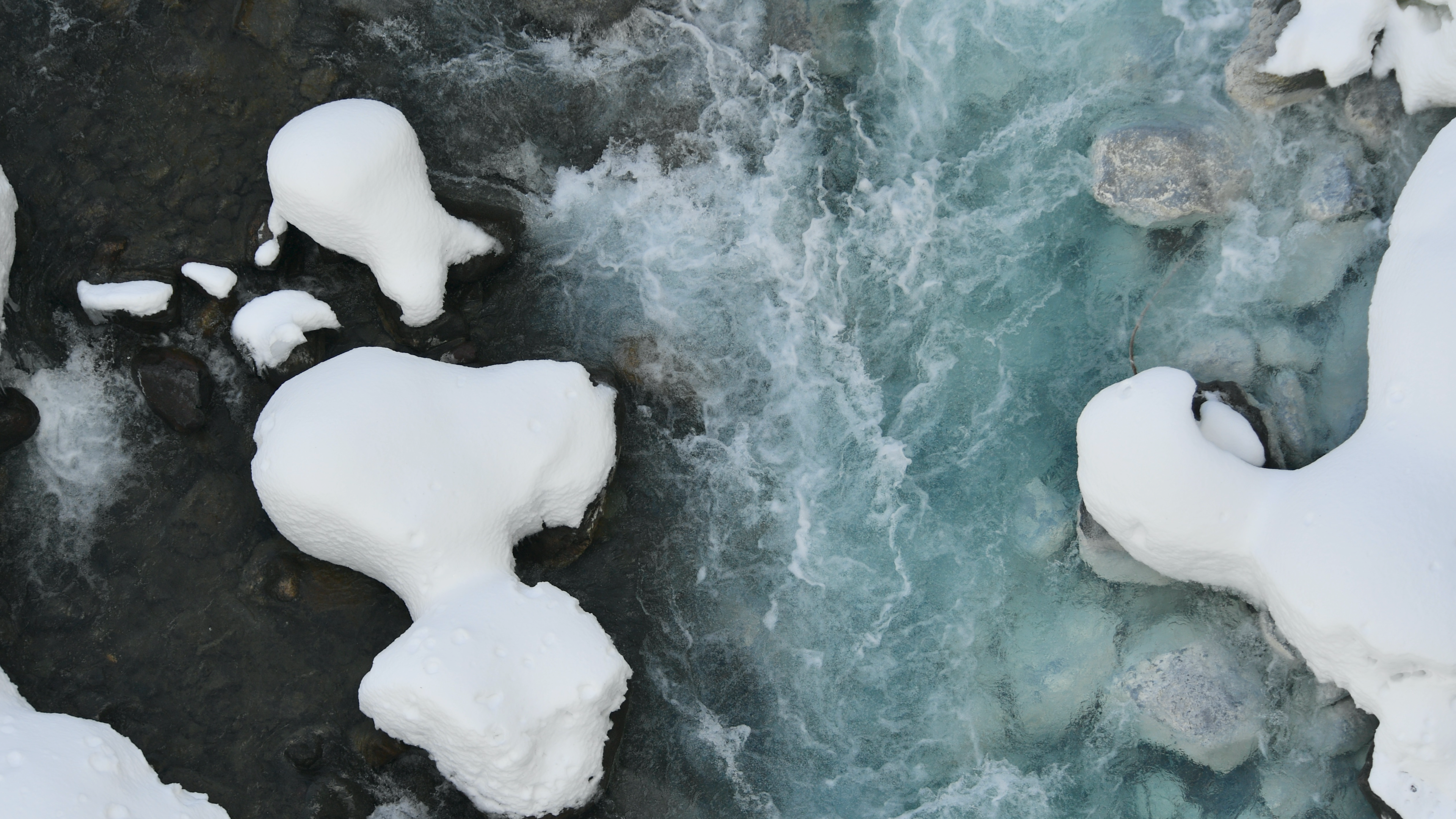 Snow-Covered Rocks in a Winter Stream · Free Stock Photo