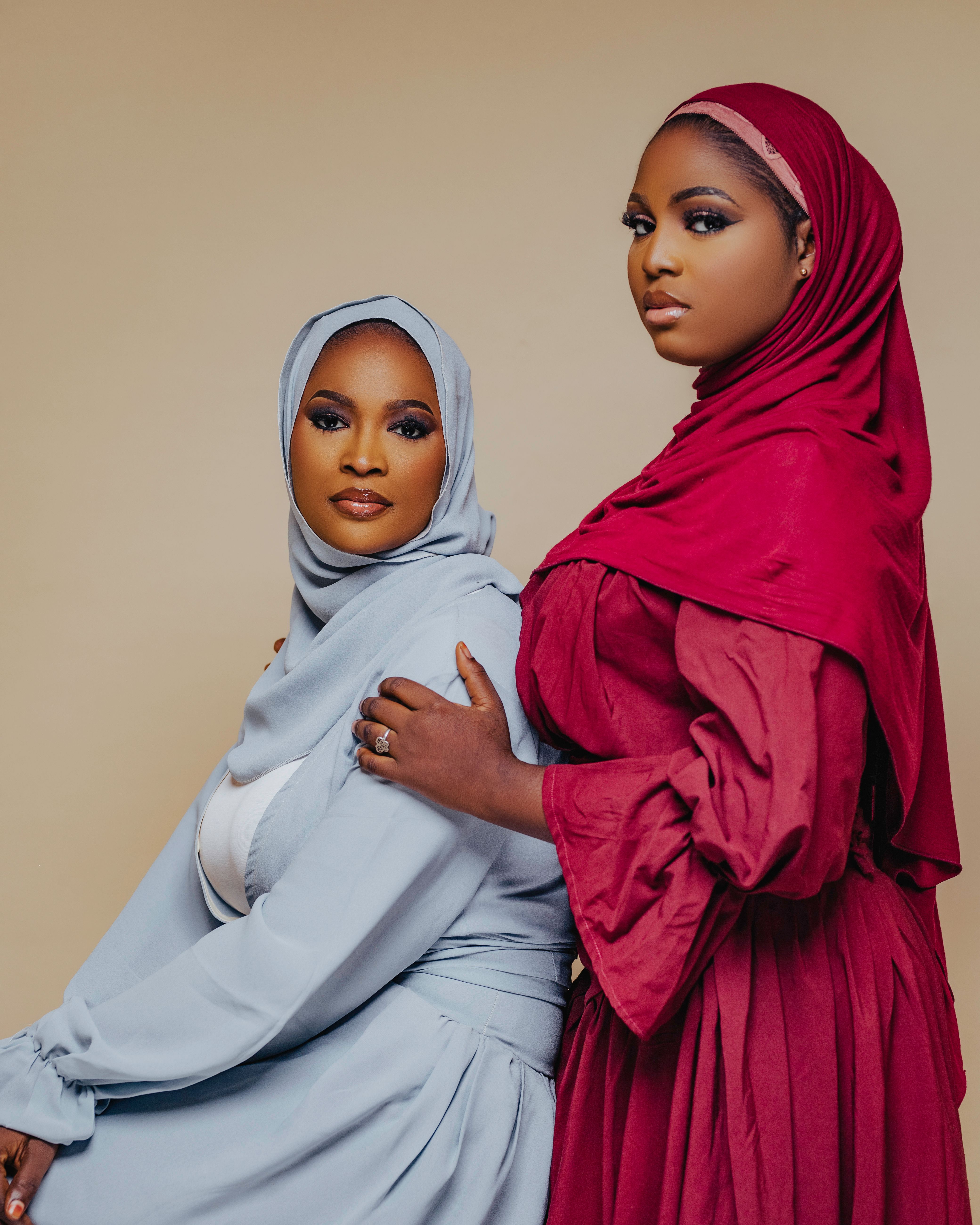 Portrait of two elegant women wearing traditional hijabs, highlighting cultural beauty and fashion.