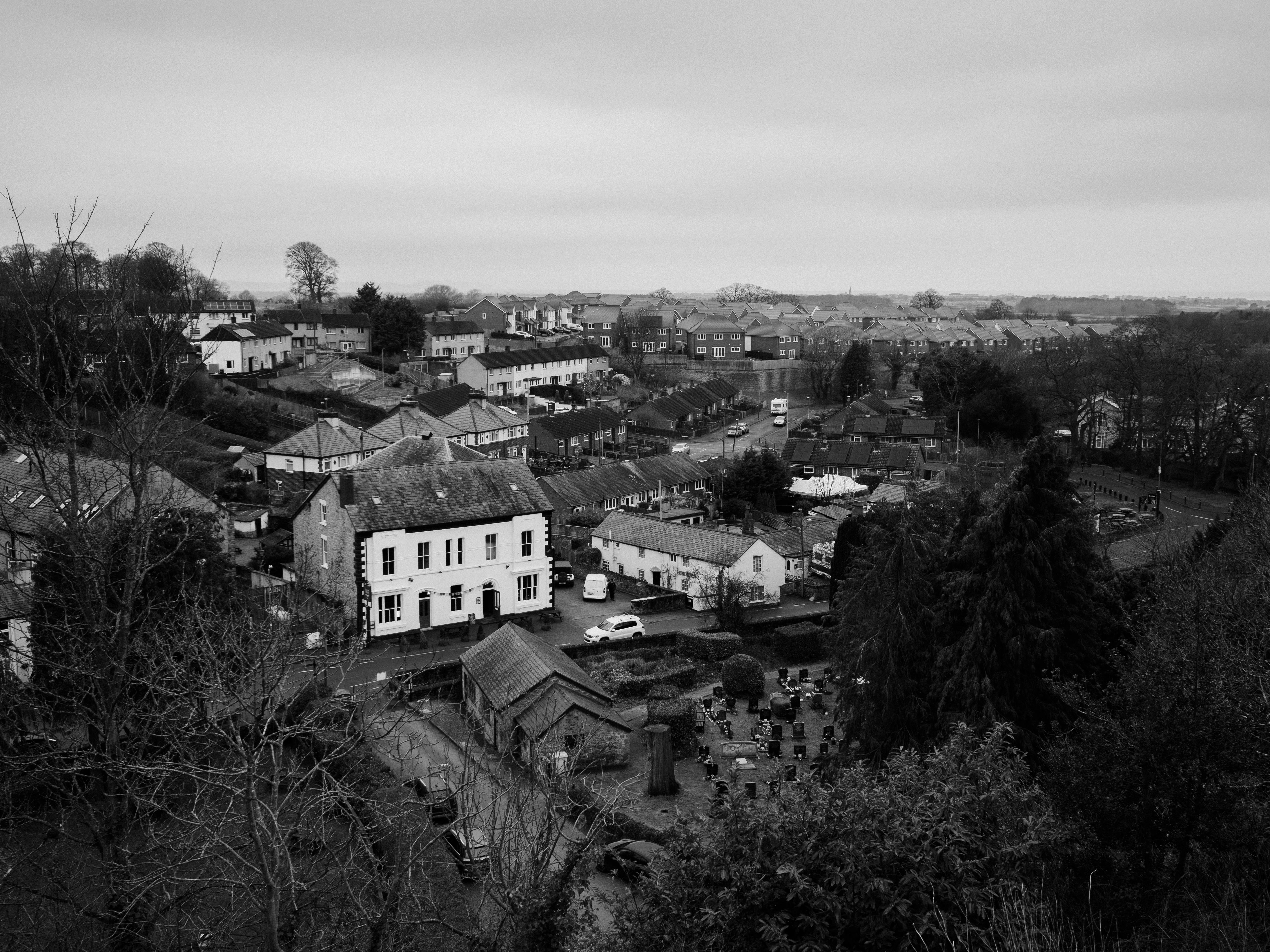 A scenic black and white aerial view of Dyserth village, showcasing residential architecture and countryside.