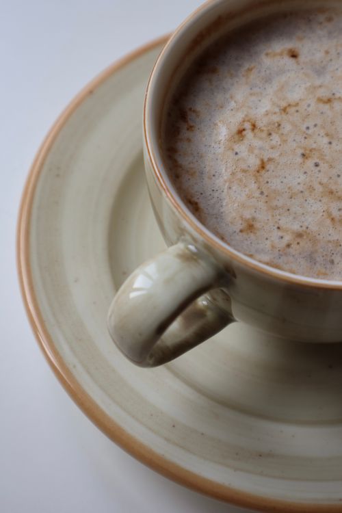 Free Close-up of a steaming cup of hot chocolate in a ceramic mug on a saucer. Stock Photo