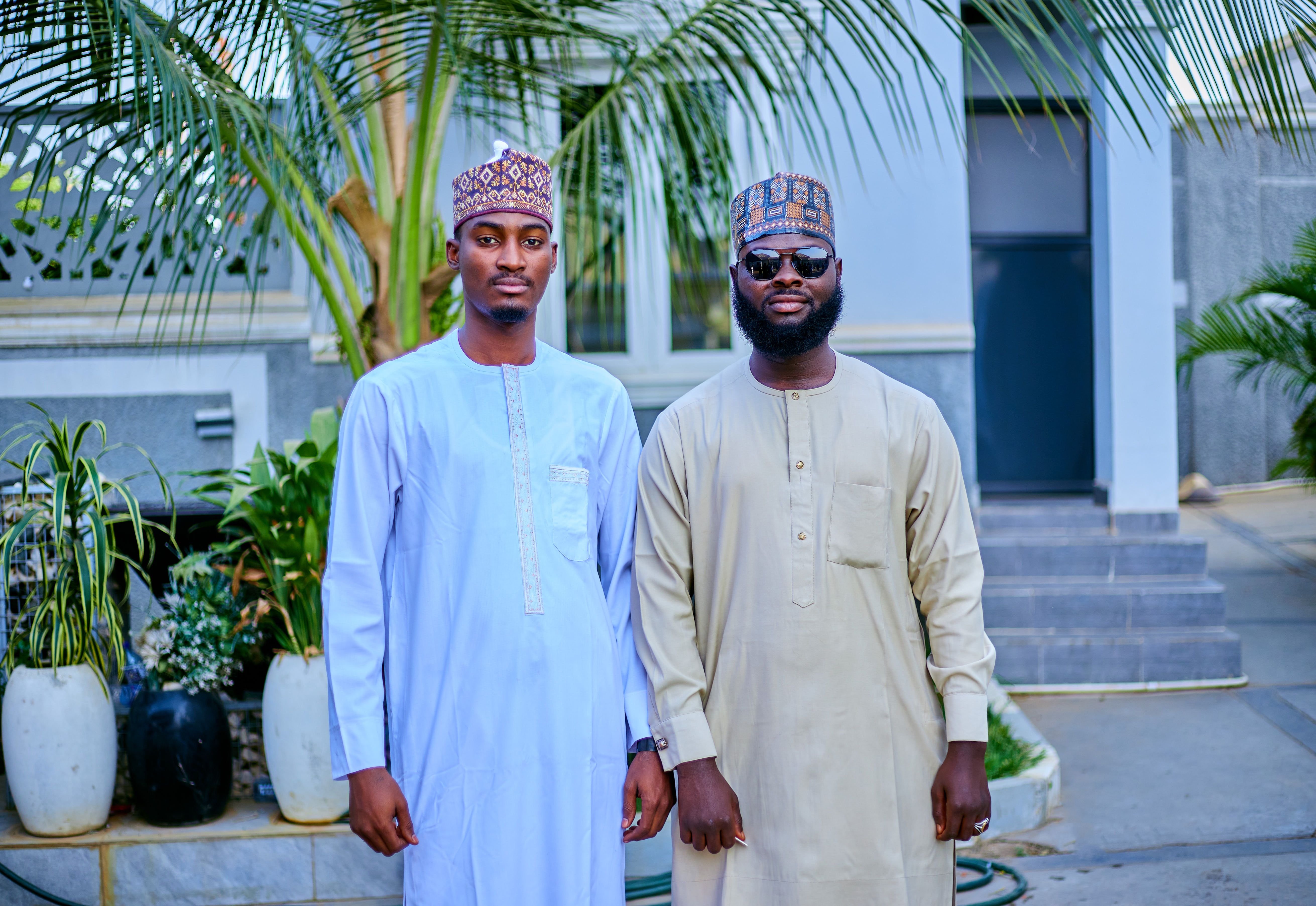 Two Men in Traditional Attire Standing Outdoors · Free Stock Photo