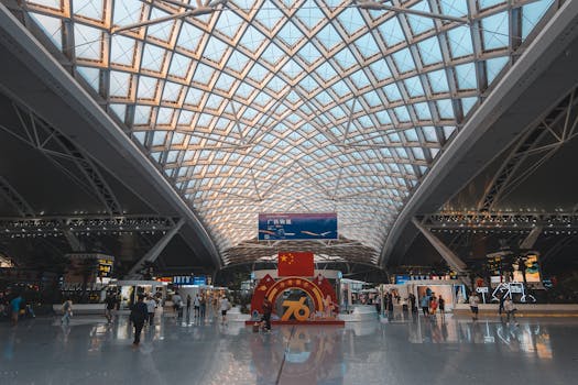 Wide view of the intricate architecture interior of Hong Kong airport with bustling travelers.