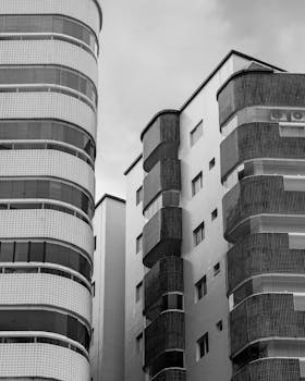 Monochrome view of modern high-rise architecture in Praia Grande, Brazil with overcast skies.