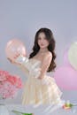 Elegant Woman Posing with Pastel Balloons