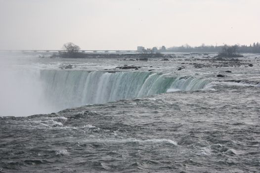 A stunning view of Niagara Falls cascading into a misty plunge pool.