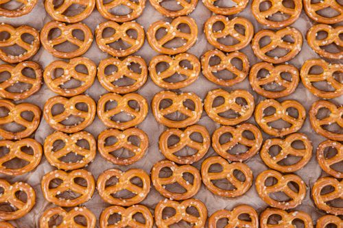 Free Top view of crunchy salted pretzels neatly arranged on baking paper. Stock Photo