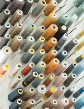Aerial view of colorful thread spools arranged in a neat pattern, showcasing texture and variety.