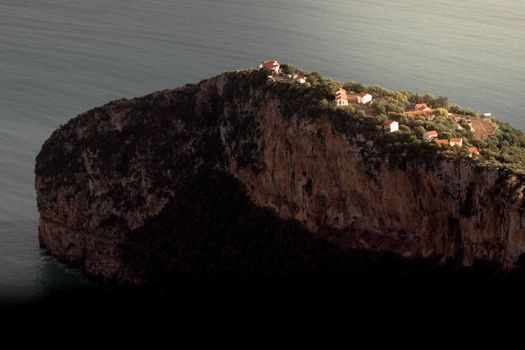 A breathtaking aerial view of a cliffside village in Béjaïa, Algeria with ocean backdrop.