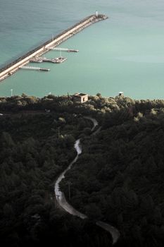 A breathtaking aerial view of the Béjaïa coastline with lush greenery and turquoise waters in Algeria.