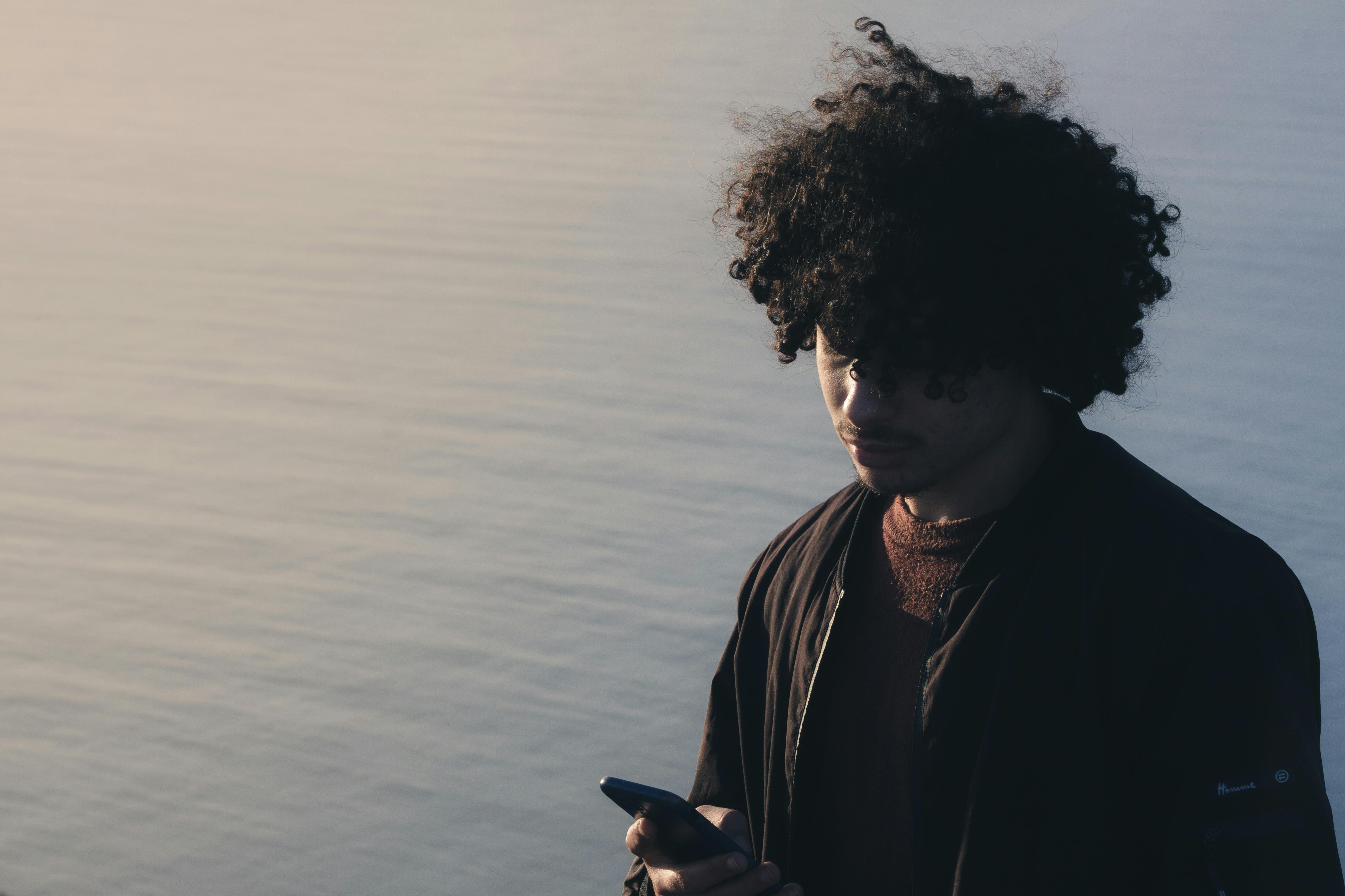 Person scrolling phone in dark experiencing TikTok brain effect