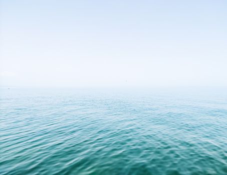 Serene ocean view with a calm sea and clear blue sky, ideal for backgrounds.