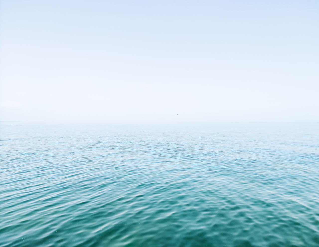 serene ocean view with a calm sea and clear blue sky ideal for backgro