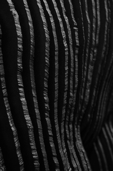 Close-up of a black and silver abstract fabric texture with striped pattern.