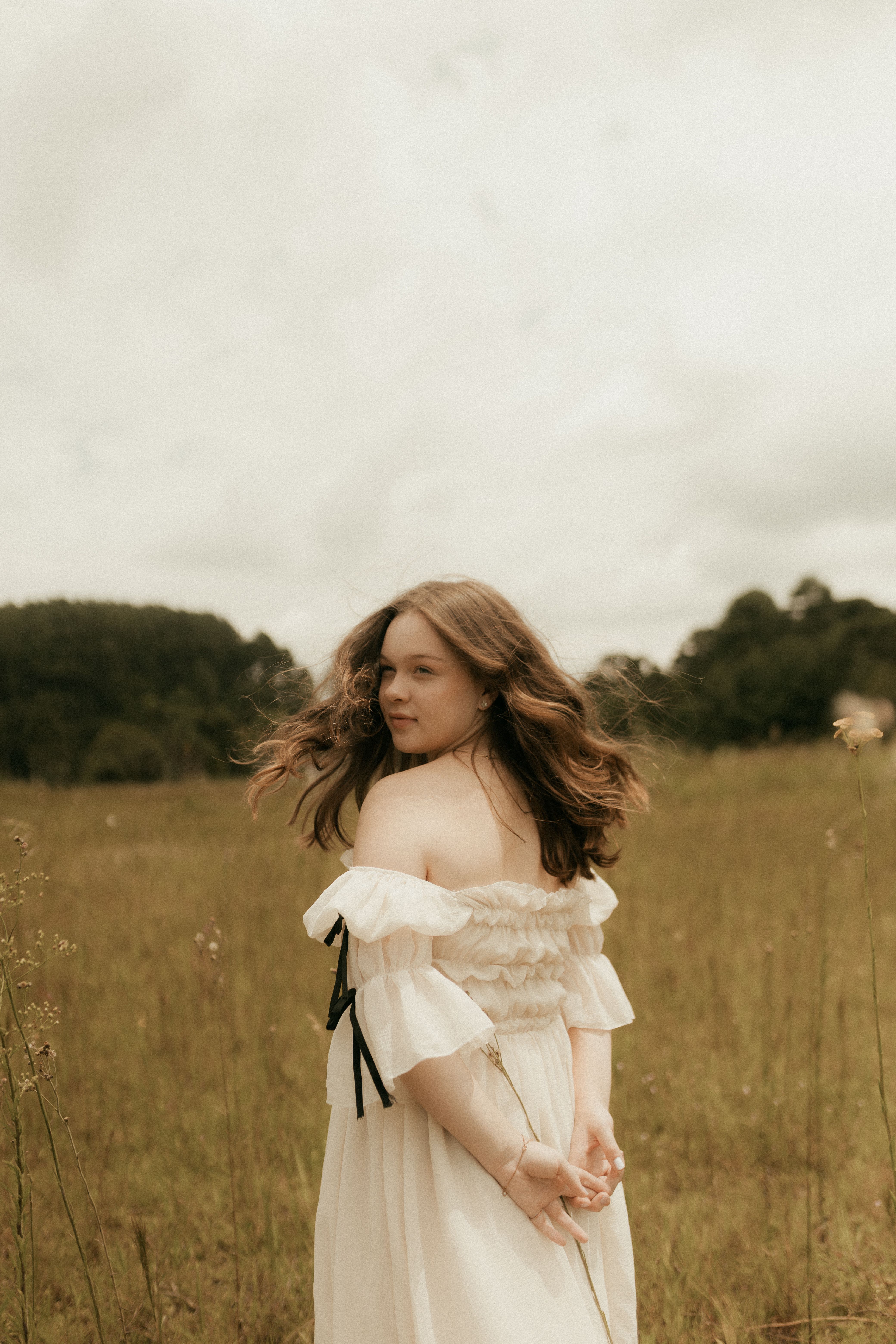 Woman in Flowing White Dress in Meadow · Free Stock Photo