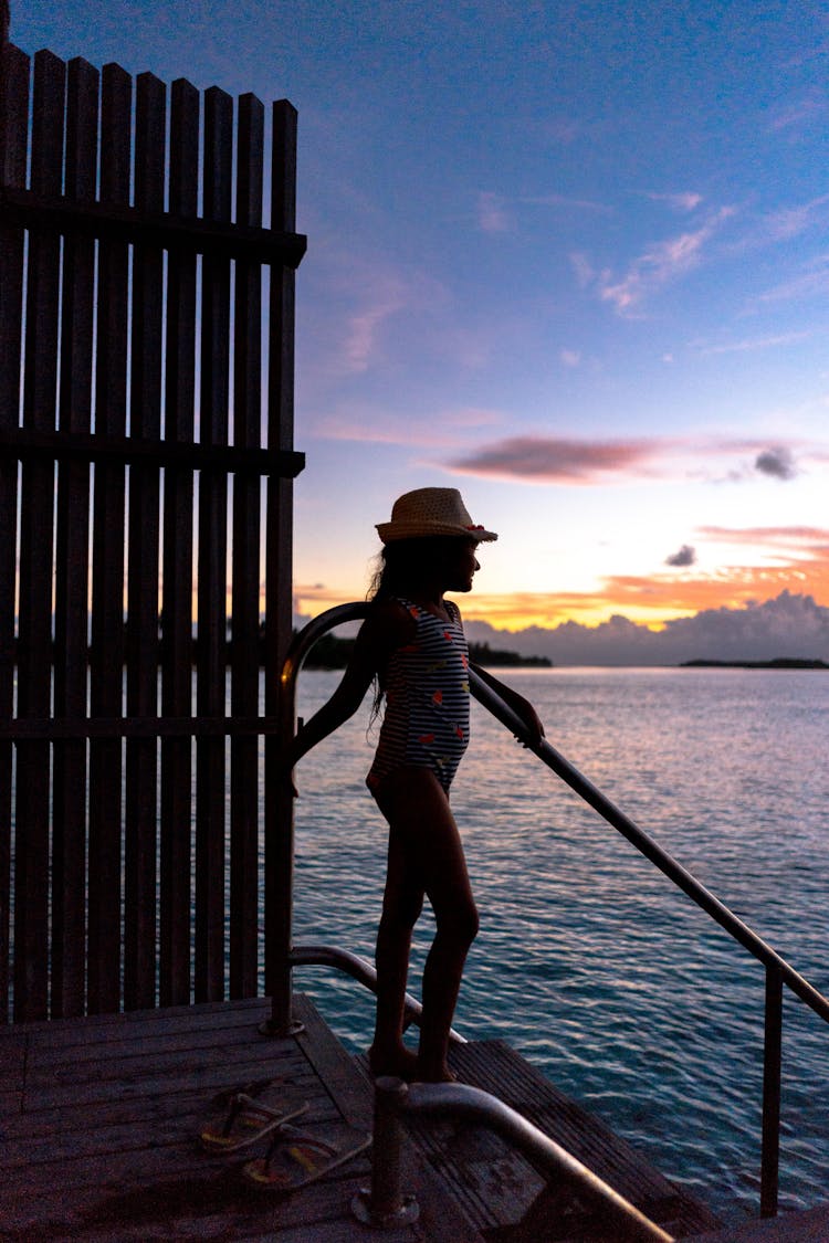 Young Kid Grasped On Hand Rail