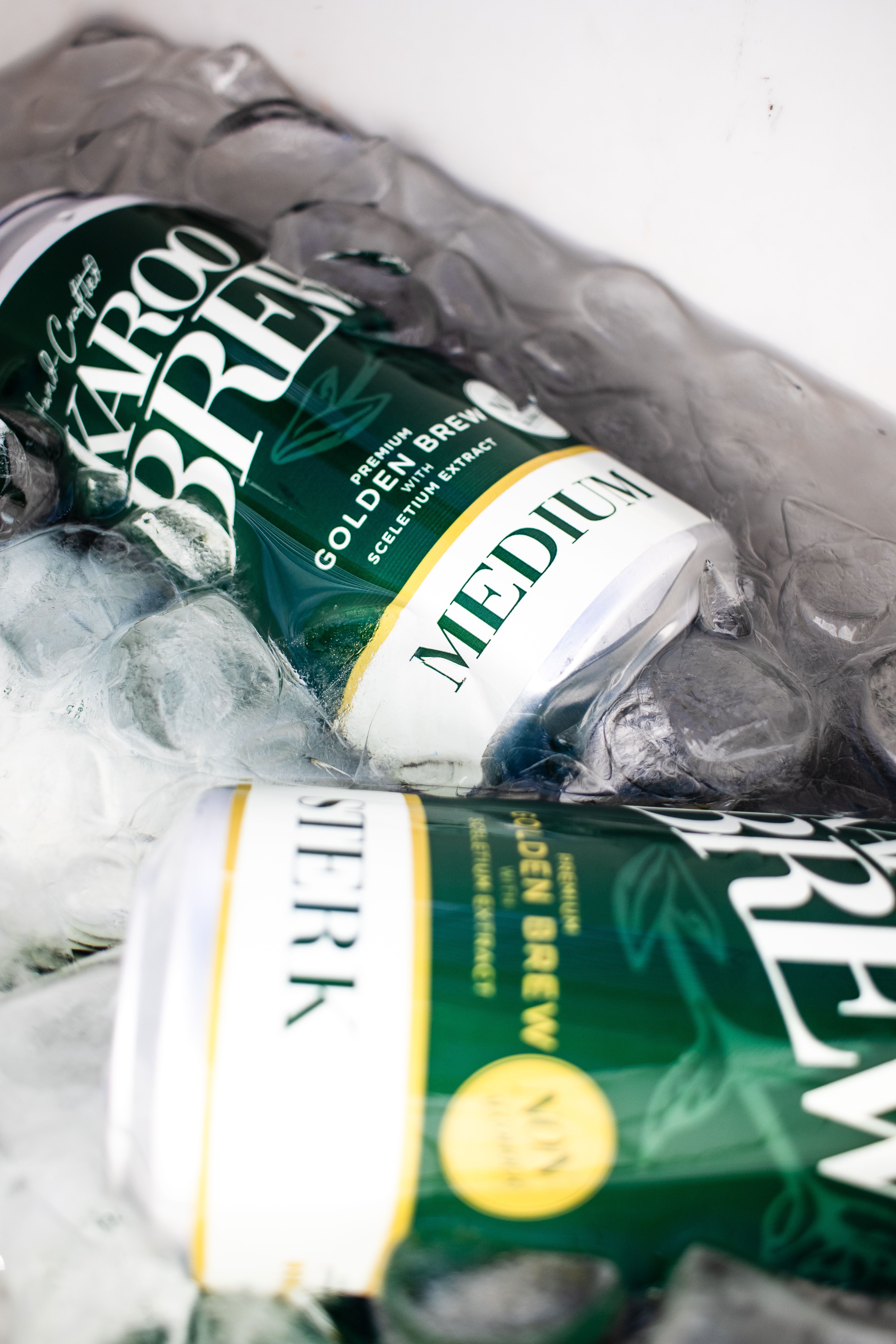 Two karoo brew cans on ice, perfect for refreshing cold drinks on a hot day.