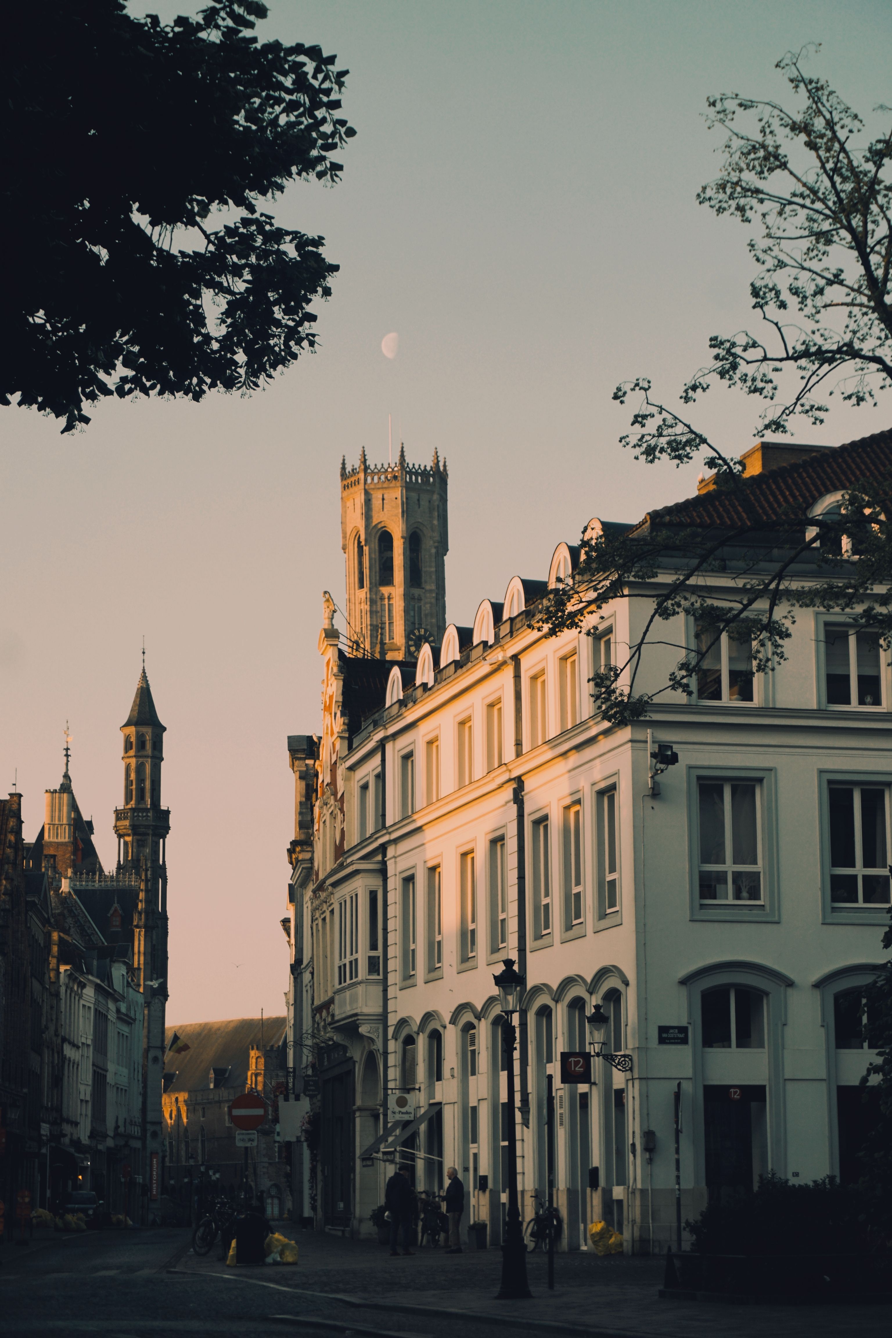 Street view of Bruges at dusk with architectural highlights and evening ambiance.