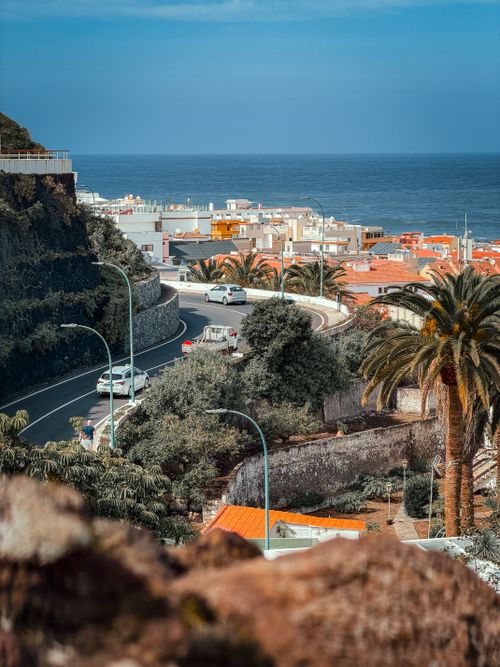 Free Beautiful coastal view of Puerto de la Cruz in the Canary Islands, featuring a winding road and vibrant townscape. Stock Photo