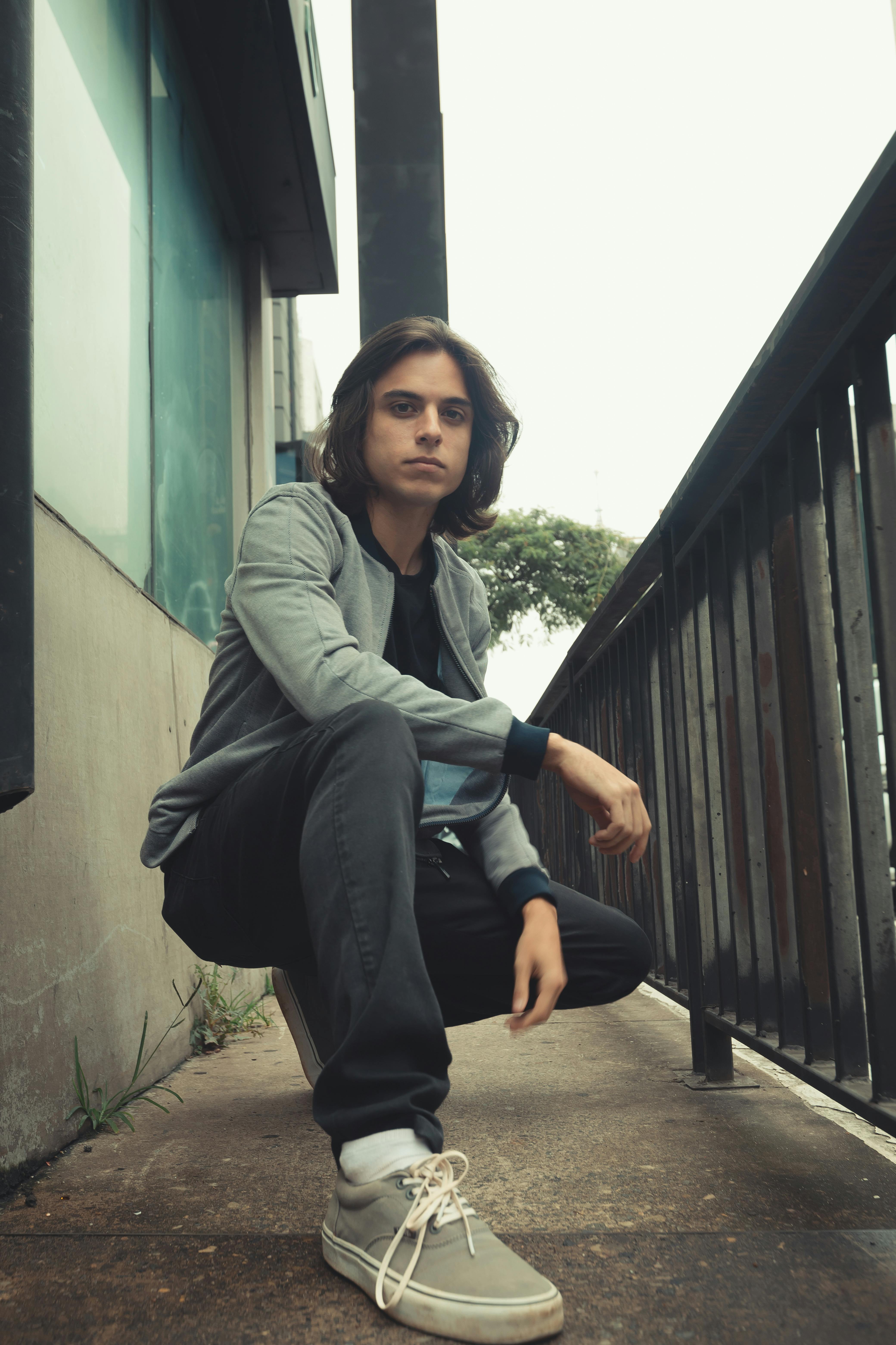 Dynamic urban portrait of a young man in São Paulo, Brazil, showcasing modern style.