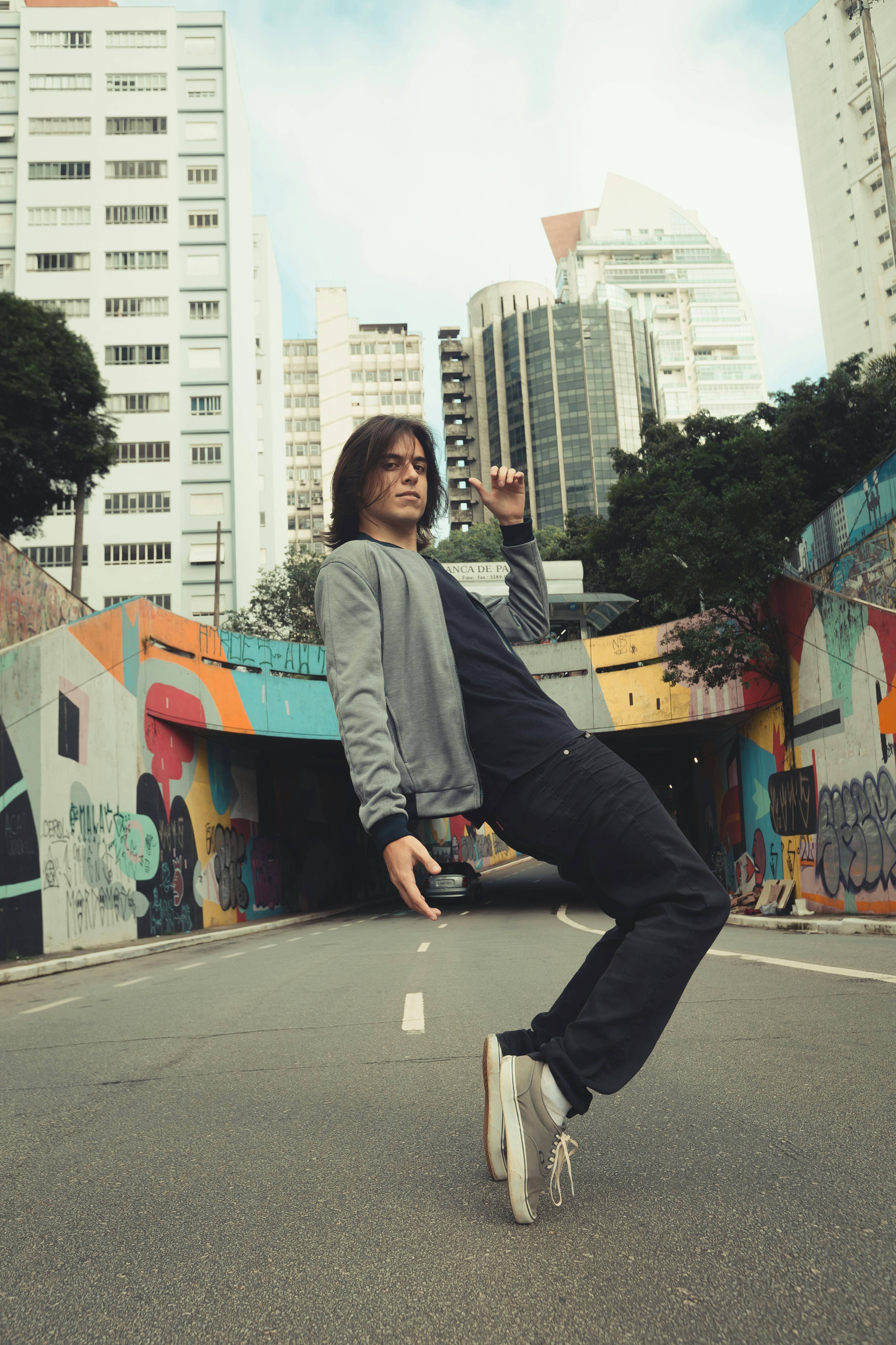 Dynamic portrait of a man posing in São Paulo's streets, showcasing contemporary urban vibes.