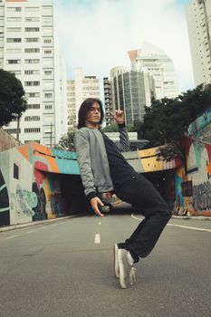 Dynamic portrait of a man posing in São Paulo's streets, showcasing contemporary urban vibes.