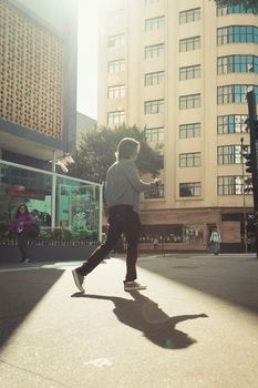 Street photography capturing a man walking through vibrant São Paulo, Brazil during the day.