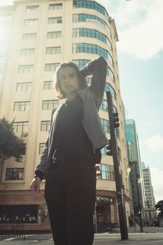 Street portrait of a man in São Paulo with sunlight and urban backdrop.