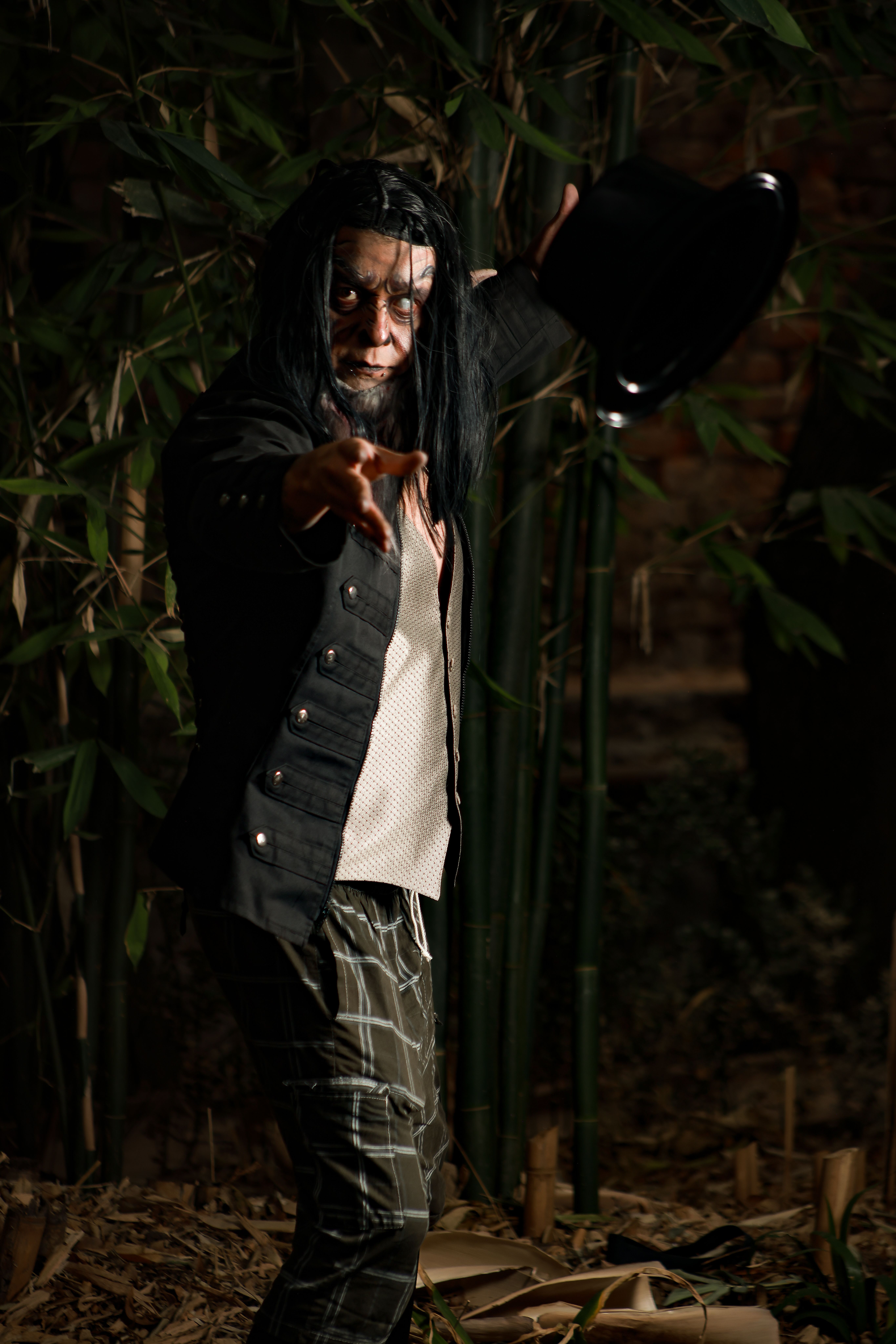 Dramatic portrait of a mysterious person in a dark forest setting.