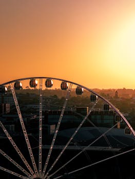 A stunning aerial view of a Ferris wheel in South Brisbane at sunset, highlighting the vibrant city skyline.