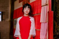 Young Woman in Red Dress at Cultural Venue