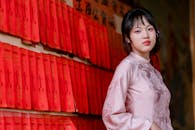 Young Woman in Traditional Silk Dress with Red Scrolls