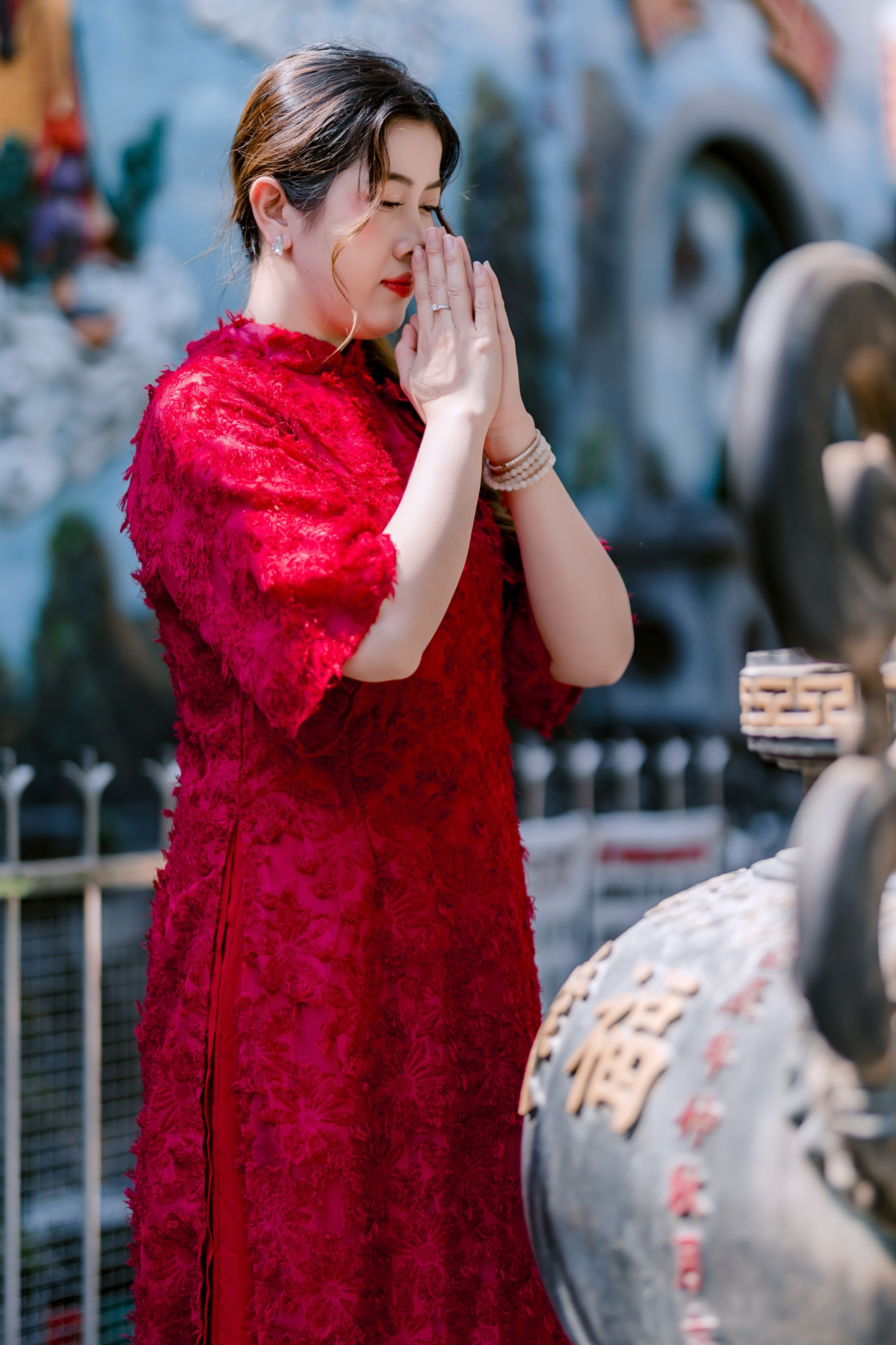 Woman Praying in Traditional Red Dress at Temple · Free Stock Photo