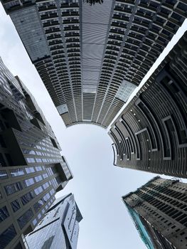 Dynamic upward view of skyscrapers in Makati City, showcasing modern urban architecture.