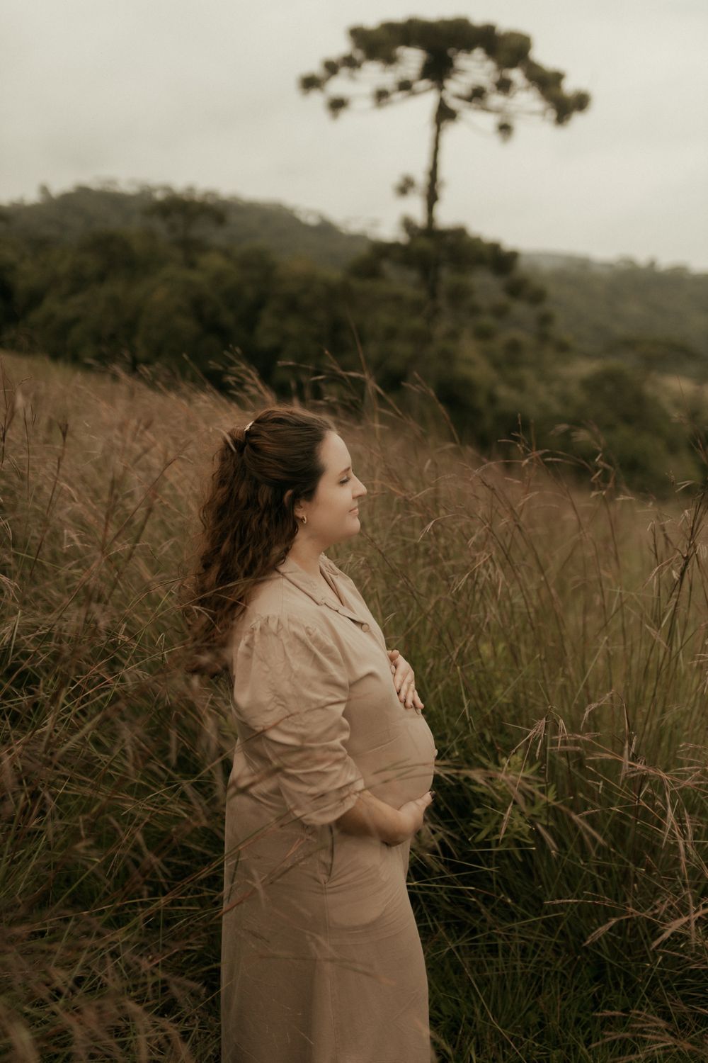 Maternity portrait standing in an open field
