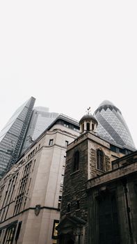 The Gherkin and historic buildings create a striking contrast in London's skyline.
