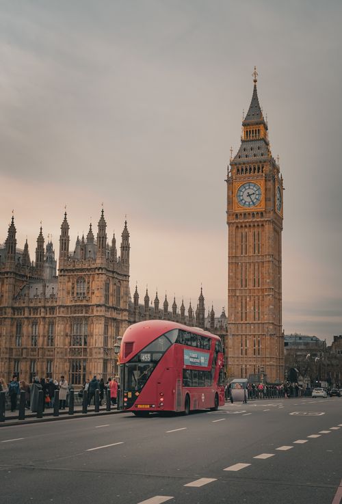 Free Capture of Big Ben and a red double-decker bus highlighting London's classic charm. Stock Photo
