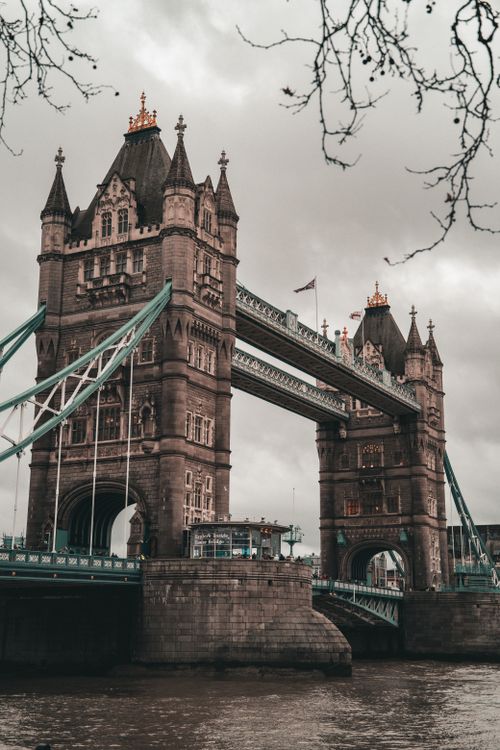 Free Stunning view of Tower Bridge in London under an overcast sky, featuring its iconic Gothic architecture. Stock Photo