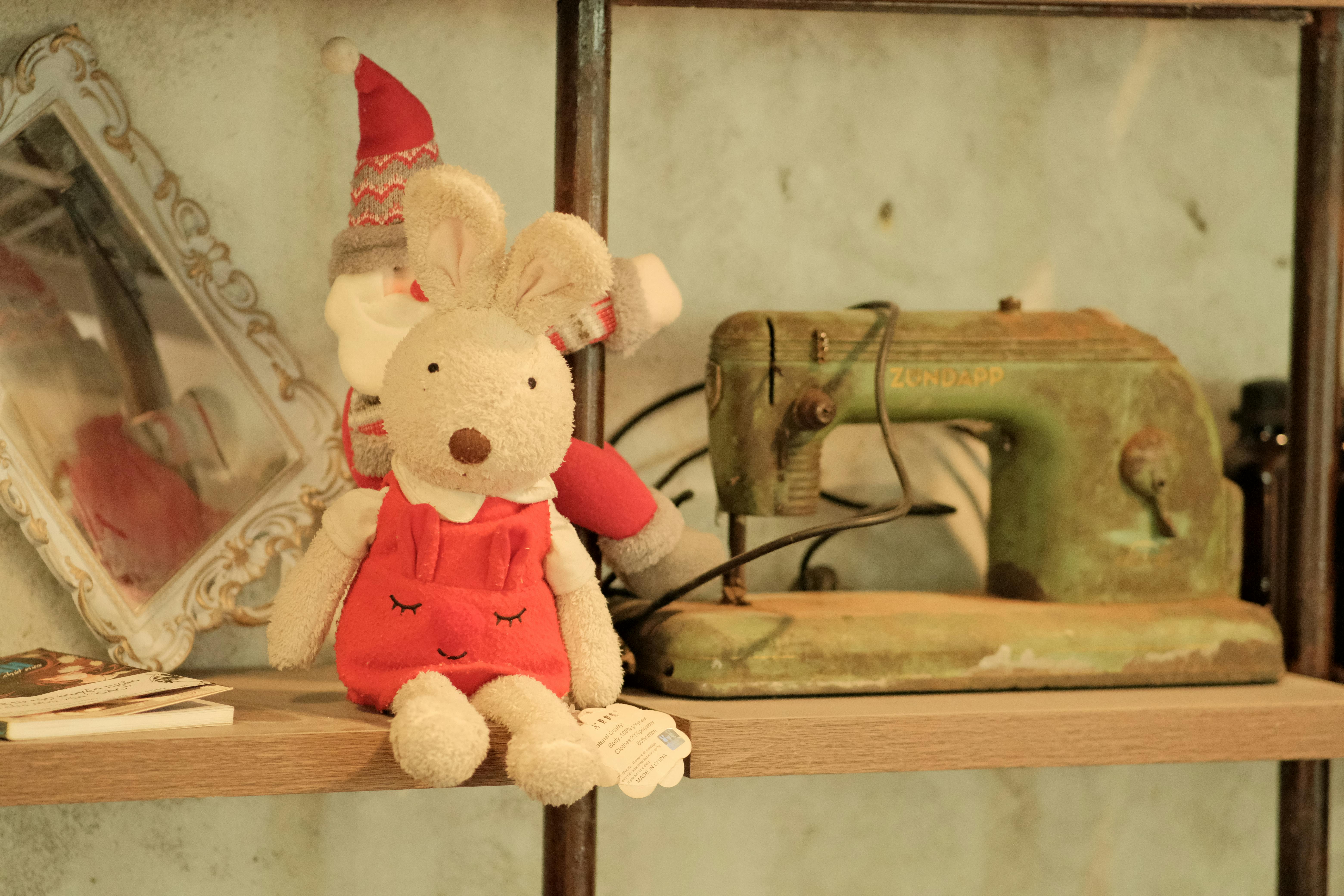 A cozy shelf with a vintage sewing machine and plush toy in Ho Chi Minh City.